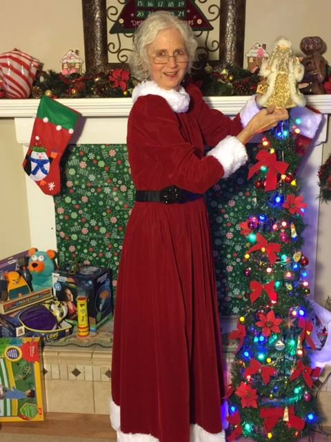 Mrs Claus topping the tree